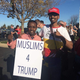 Abdi Rage (right) in a Make America Great Again hat.